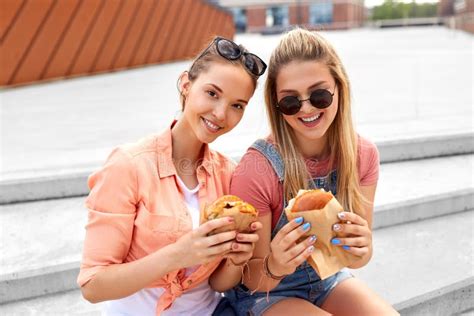 Teenage Girls Or Friends Eating Burgers Outdoors Stock Image Image Of
