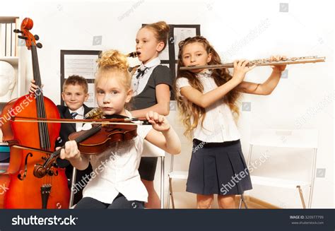School Children Playing Musical Instruments Together Stock Photo