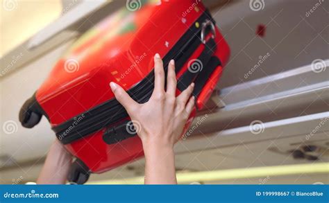 Cabin Crew Lift Luggage Bag In Airplane Stock Image Image Of Carry