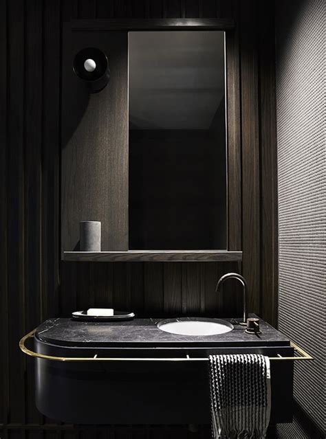 Modern Bathroom Space With Dark Wood Panels A Black Marble Counter And