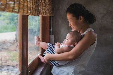 Asian Nursing Mother By Stocksy Contributor Chalit Saphaphak Stocksy