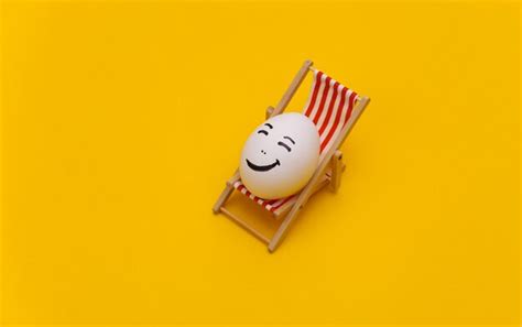 Premium Photo Chicken Egg With Hand Drawn Happy Face On Beach Deck