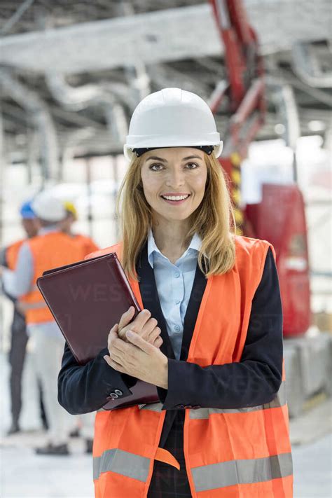 Portrait Smiling Female Engineer At Construction Site Stock Photo