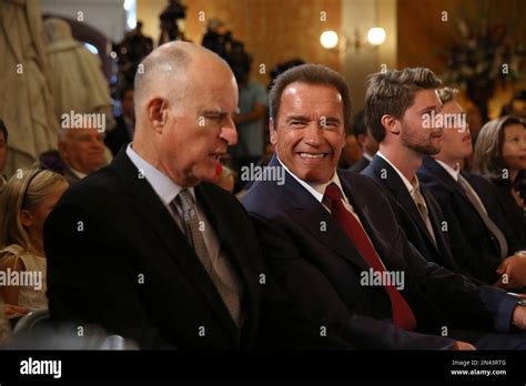 Former Gov. Arnold Schwarzenegger, second from right, smiles as he