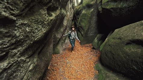 Woman Exploring A Cave In The Forest Free Stock Video
