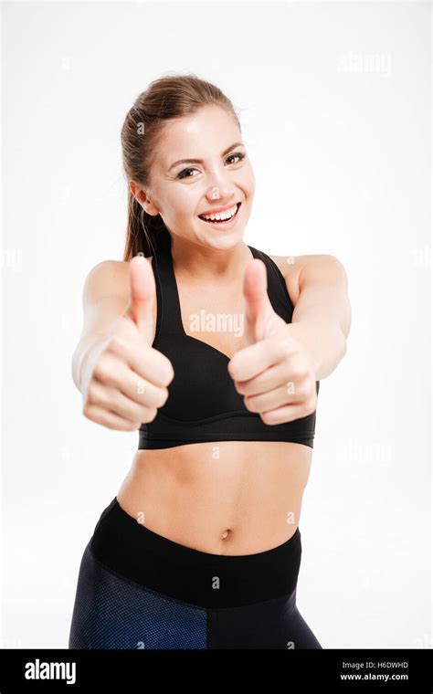 Smiling Sporty Woman Showing Thumb Up Sign Over White Background Stock Photo Alamy