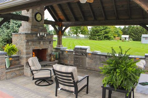 Located at a nice a outdoor patio, the outdoor kitchen is strategically placed at a wall covered by the roof eaves, protecting most of the cabinets/appliances installed. 7 Outdoor Kitchen Design Ideas | Unique & Stylish Designs