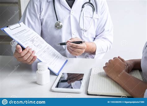 Doctor Consulting With Patient And Checking Sickness Condition While