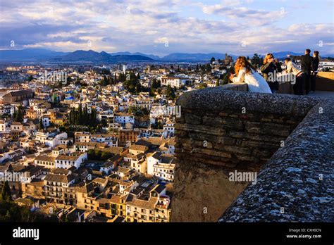 Tourists Looking At The Albaicin Quarter From The Alcazaba Towers Of