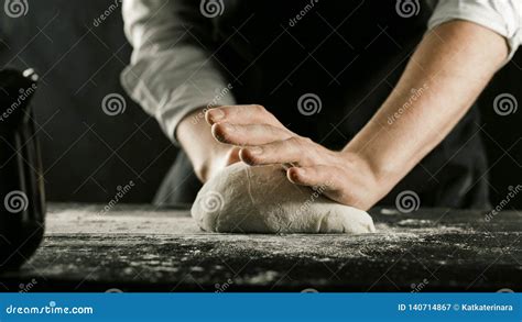 Male Chef Hands Knead Dough With Flour On Kitchen Table Stock Image