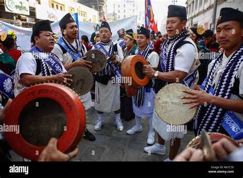 Nepalese Men From Ethnic Gurung Community In Traditional Attire Play Traditional Drum As They