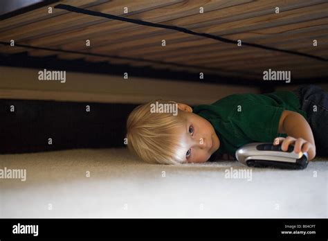 Boy Hiding Under Bed Stock Photo Alamy