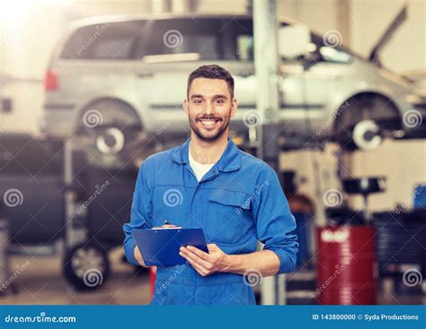 Happy Mechanic Man With Clipboard At Car Workshop Stock Photo Image