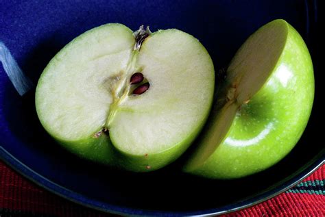 A Green Apple Cut In Half In A Blue Bowl By Rebecca E Marvil
