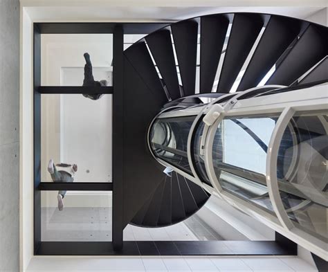 Spiral Staircase And Glass Elevator Breaking Through Transparent Floors