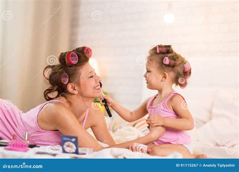 Mom And Daughter In The Bedroom On The Bed In The Curlers Make U Stock Image Image Of Girl