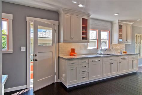 Gray Kitchen With White Tile Backsplash And Orange Accents Kitchen