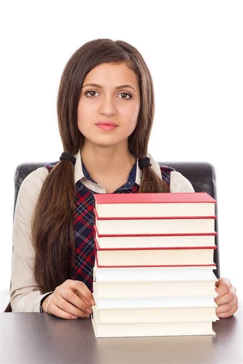 Portrait Of A Schoolgirl With A Stack Of Books Sitting At Her D Stock