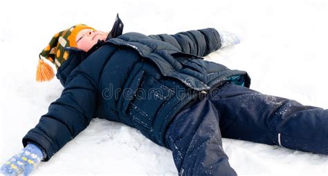 Happy Little Boy Making Snow Angels In The Snow Stock Image Image Of