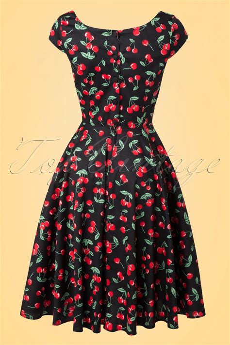 Hard black cherry flavor candy on the outside, gum on the inside. 50s Cherry Pop Swing Dress in Black