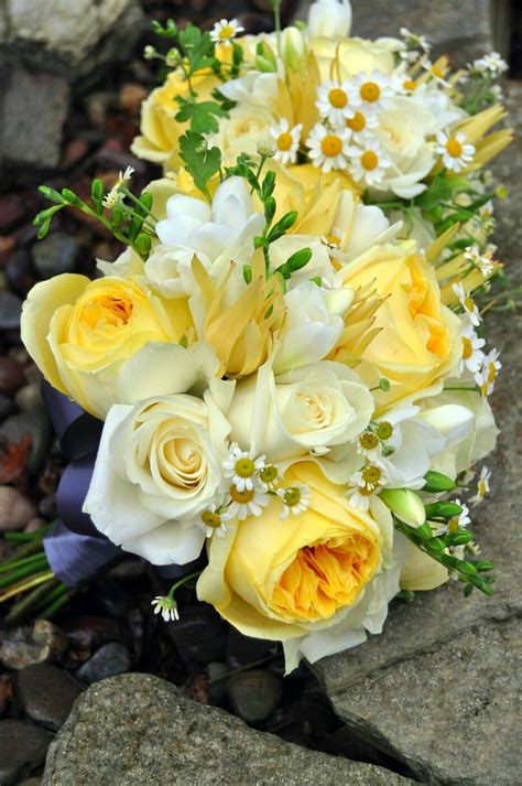 pretty and cheerful wedding bouquets arranged with ivory roses white freesia white yellow