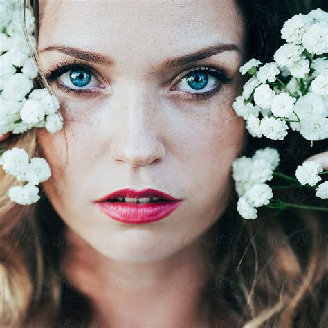 Portrait Of A Beautiful Young Woman With Freckles And Blue Eyes By