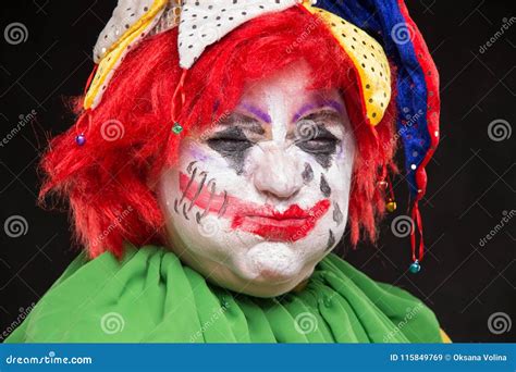 A Horrible Clown With A Terrible Make Up And Hat Laughing On A B Stock
