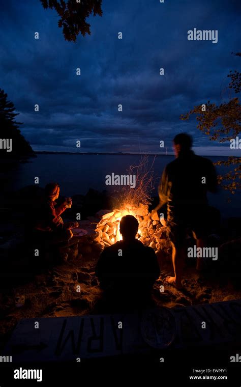Three People Sitting Around Campfire Hi Res Stock Photography And