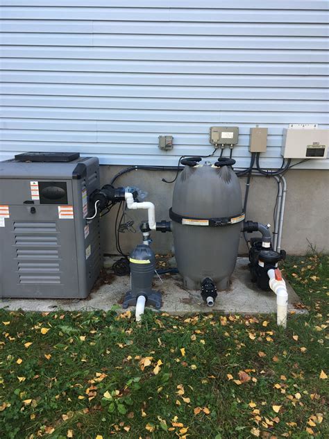 An Air Conditioner And Water Heater Are Outside In The Grass Next To A