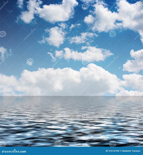 White Clouds In The Blue Sky Reflected In The Water Stock Image Image