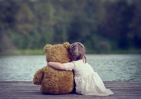 Cute Baby Girl Hugging Teddy Bear