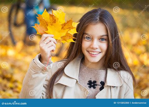 Portrait Of A Beautiful Brunette Little Girl Autumn Park Outdoors