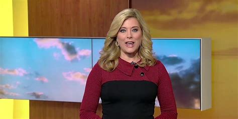 A Woman In A Red And Black Dress Is Talking On The Television Set With