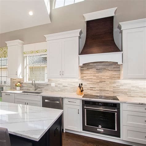 The backsplash seen here is comprised of narrow tiles stacked in columns, which instantly provides this white and mint kitchen a modern edge. Modern White Gray Subway Marble Backsplash Tile
