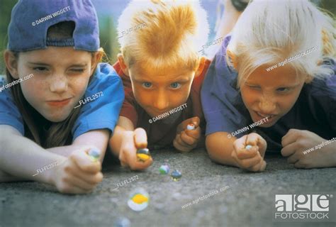 Children Playing Marbles Stock Photo Picture And Rights Managed Image
