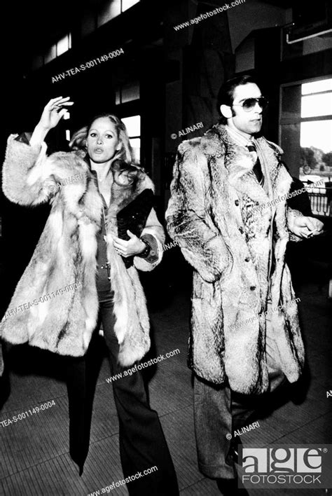 Ursula Andress And Fabio Testi Walking Together In Elegant Furs Shot