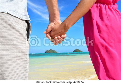 beach couple in love holding hands on honeymoon pink dress casual beachwear romantic newlyweds