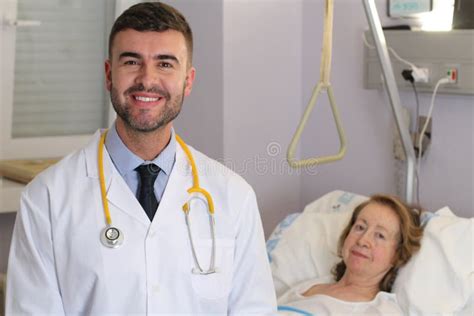 Handsome Doctor In Hospital Room With Patient Stock Photo Image Of