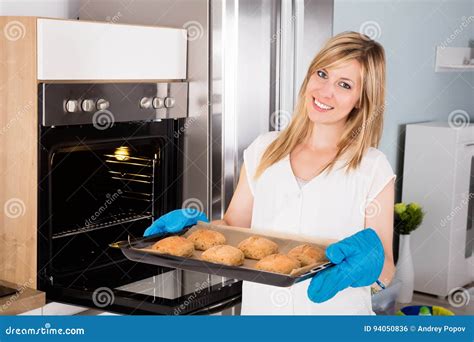 Woman Holding Tray Full Of Cookies Near Oven Stock Photo Image Of