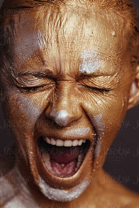 Woman With Painted Face Screaming In Studio By Stocksy Contributor