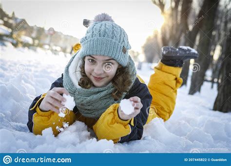 Portrait Little Girl In Snow Lying On The Ground Stock Photo Image Of