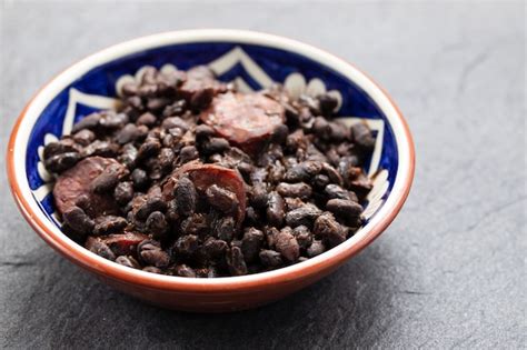 Premium Photo Black Beans With Smoked Sausages In Ceramic Dish