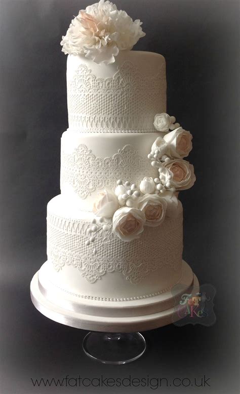 edible lace wedding cake with soft pastel sugar flowers half cascade of flowers with fringed