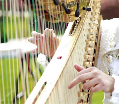 Young Woman Playing A Harp — Stock Photo © Alan 112169606