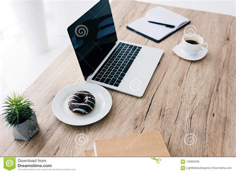 Closeup View Of Laptop With Blank Screen Doughnut Coffee Cup Potted