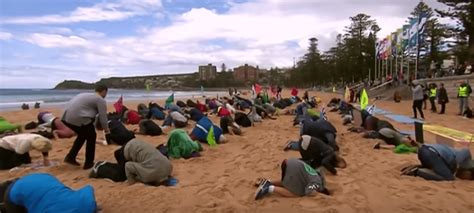 Climate Activists Bury Their Heads In The Sand In Sydney Australia