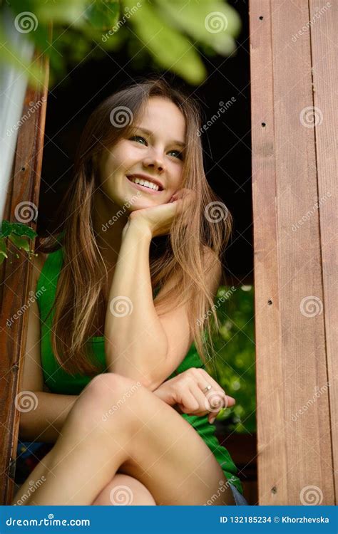 Outdoor Portrait Of Cheerful Attractive Teen Girl In Garden Wood Stock