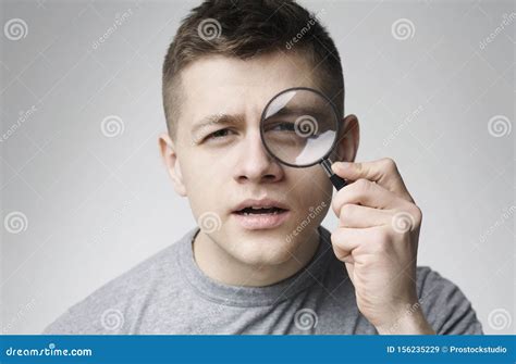 Curious Young Man Looking Through Magnifying Glass Stock Image Image