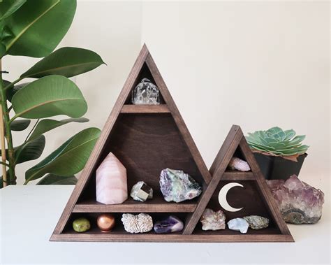 A Wooden Shelf With Rocks And Plants On It