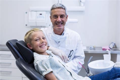 Portrait Of Smiling Dentist And Young Patient Stock Image Image Of